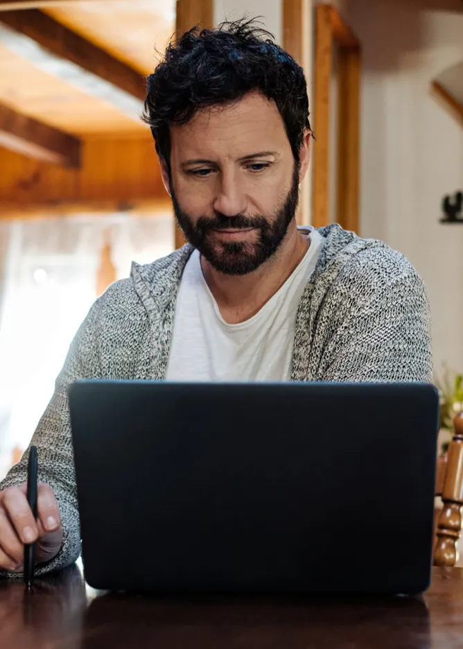 Man using laptop at home.